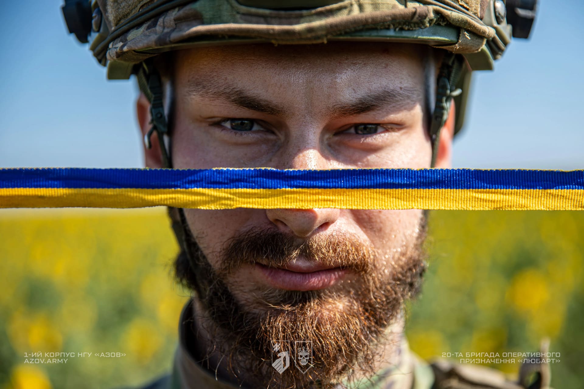 Боєць бригади Любарт тримає в руках жовто-блакитну стрічку