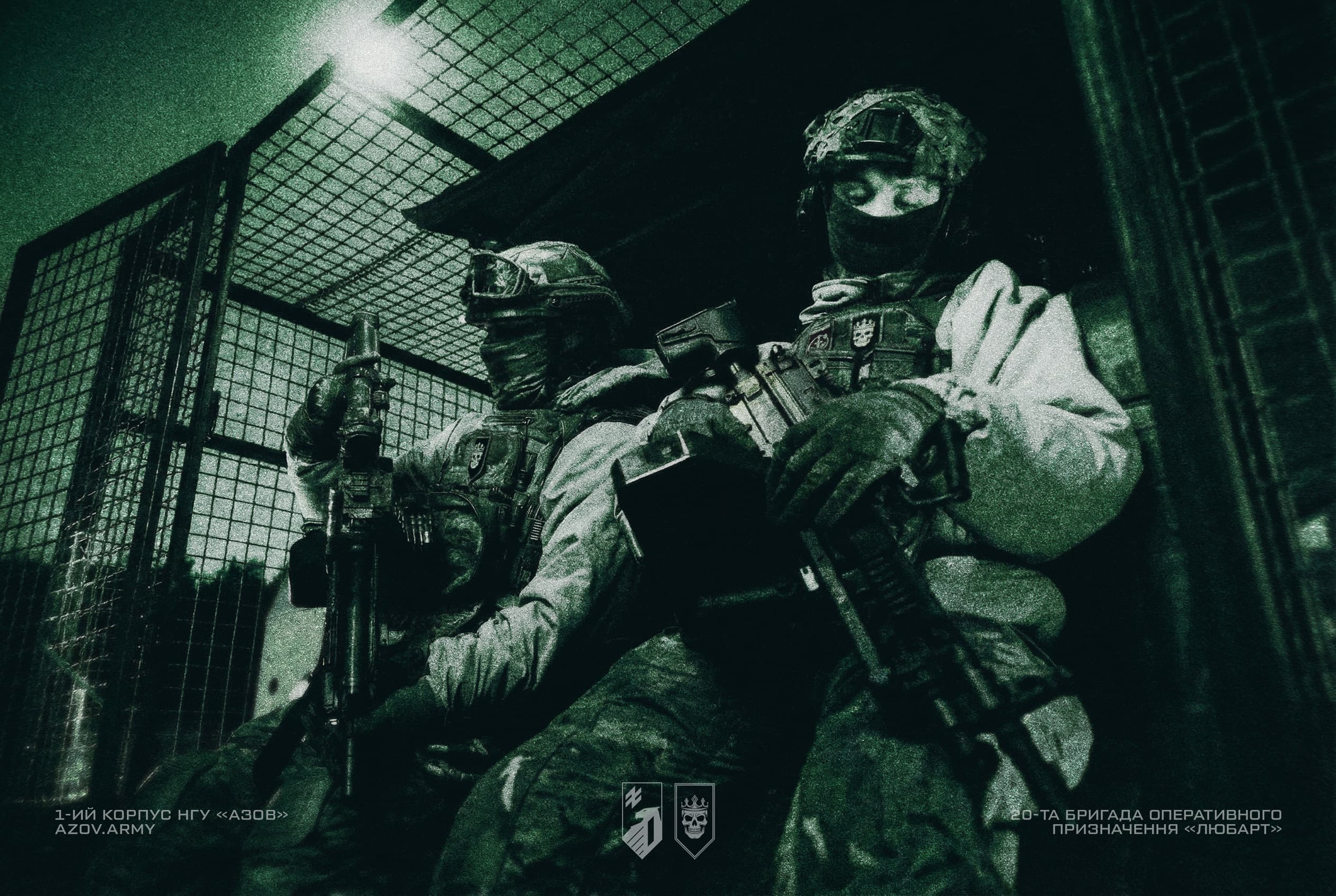 Двоє військових зі зброєю біля авто із захисною сіткою