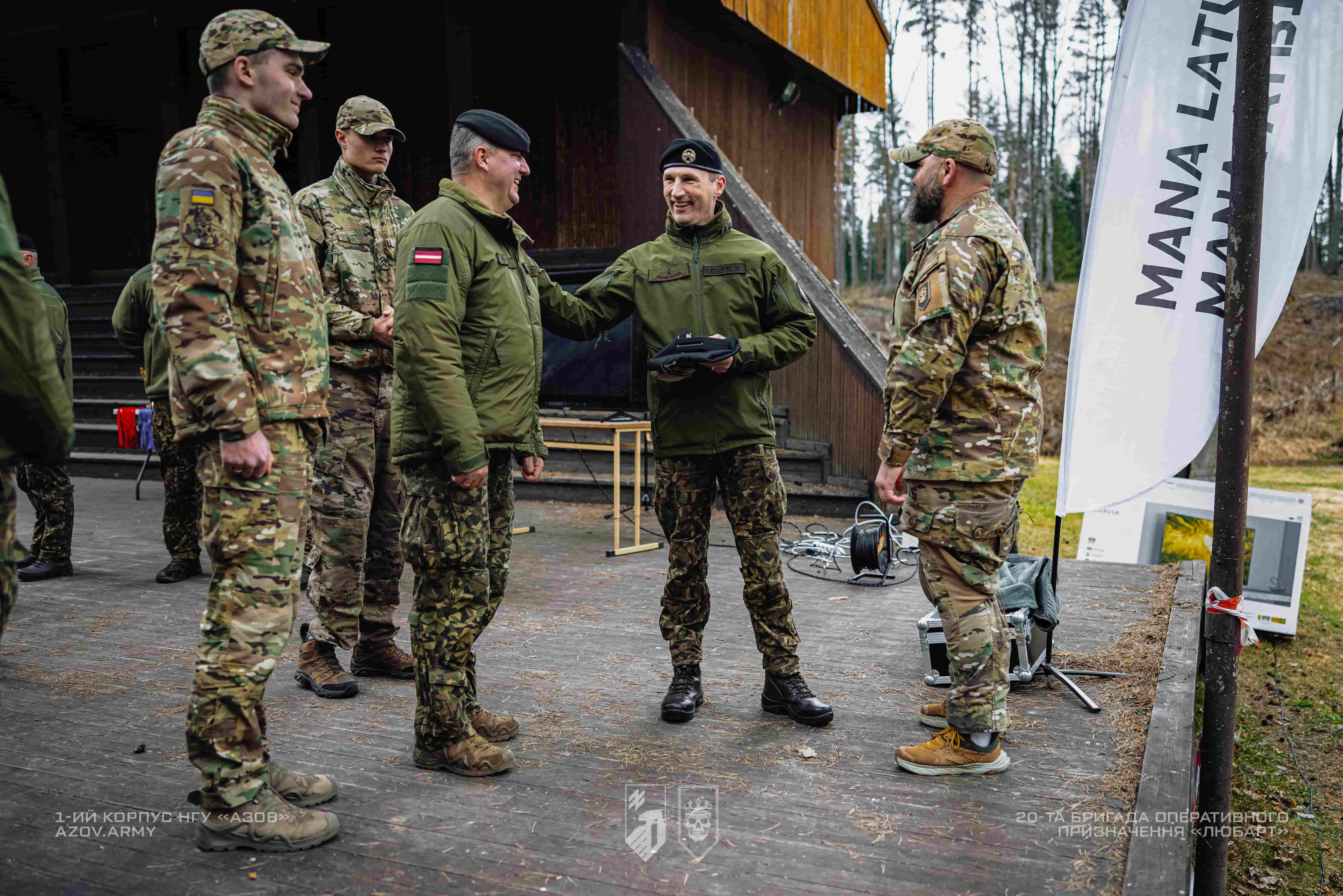 військові спілкуються під час зустрічі біля сцени на відкритому майданчику